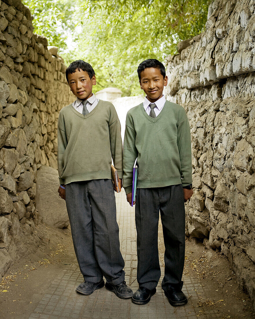 two well dressed indian boys on their way to school.