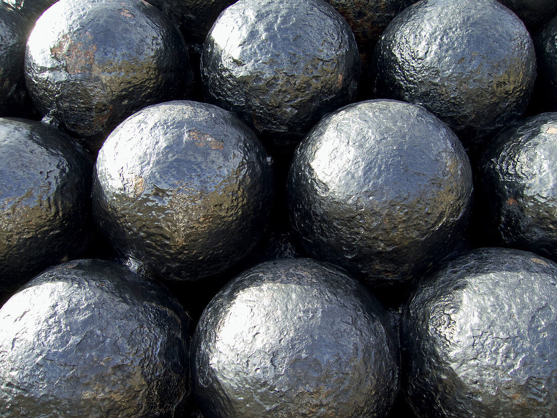 a graphic close up shot of cannonballs stacked