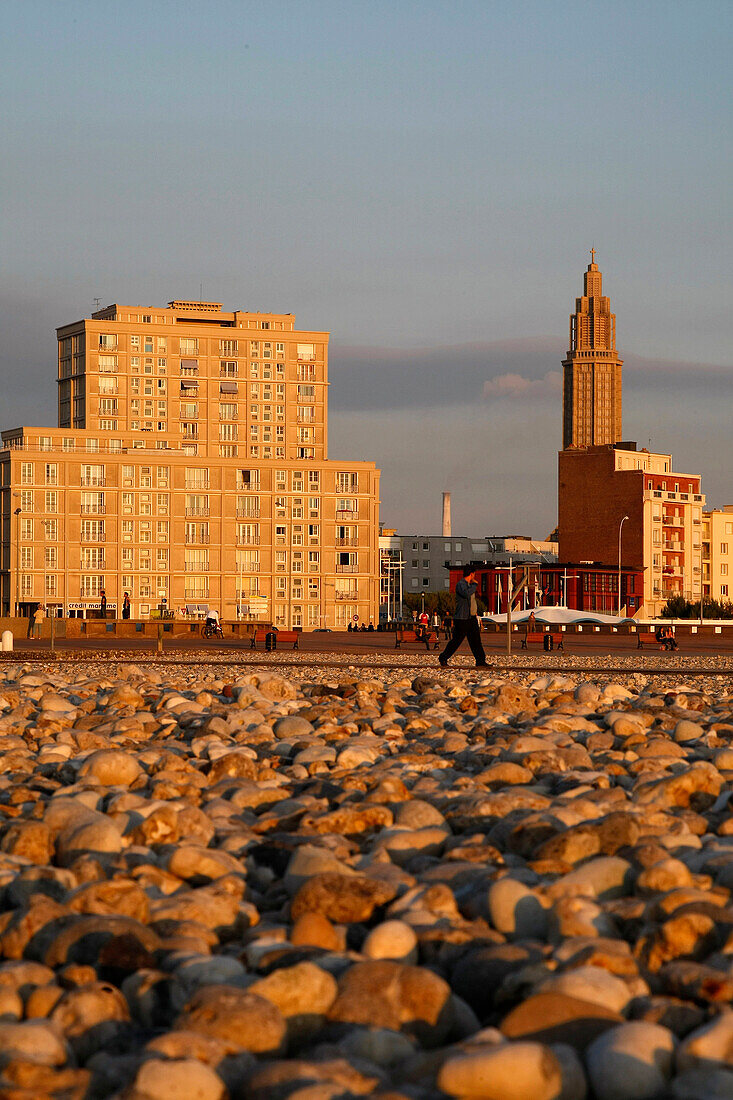 Shingle Beach At Sunset In Front Of The Buildings And Saint-Joseph Church Built By The Architect Auguste Perret, Classed As A World Heritage By Unesco, Le Havre, Seine-Maritime (76), Normandy, France