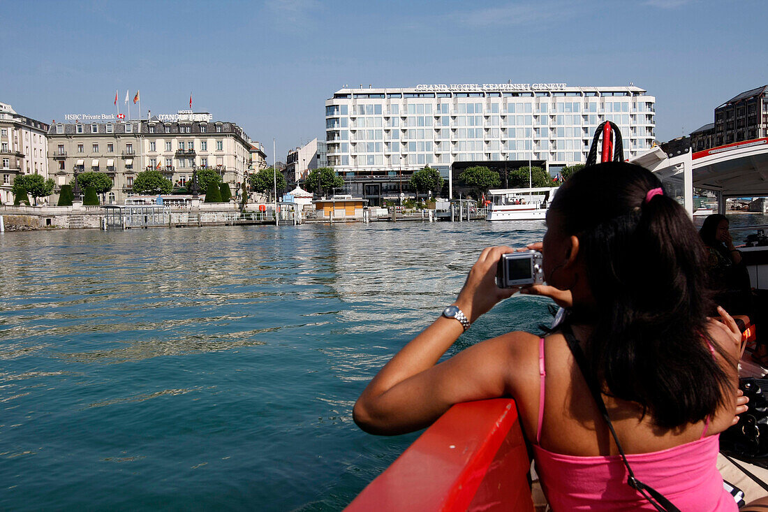 Tourist On A Taxi Boat In Front Of The Grand Hotel Kempinski Of Geneva, Switzerland