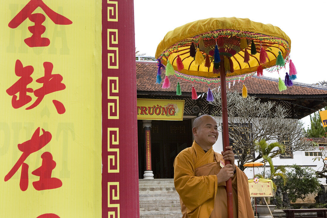 Buddhistic monk holding umbrella at the Linh Son Pagoda at Dalat, Lam Dong Province, Vietnam, Asia