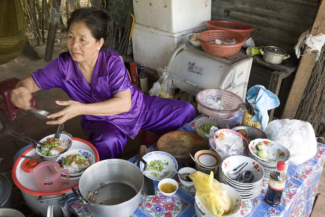 Woman at a cookshop on the street, Mui Ne, Binh Thuan Province, Vietnam, Asia