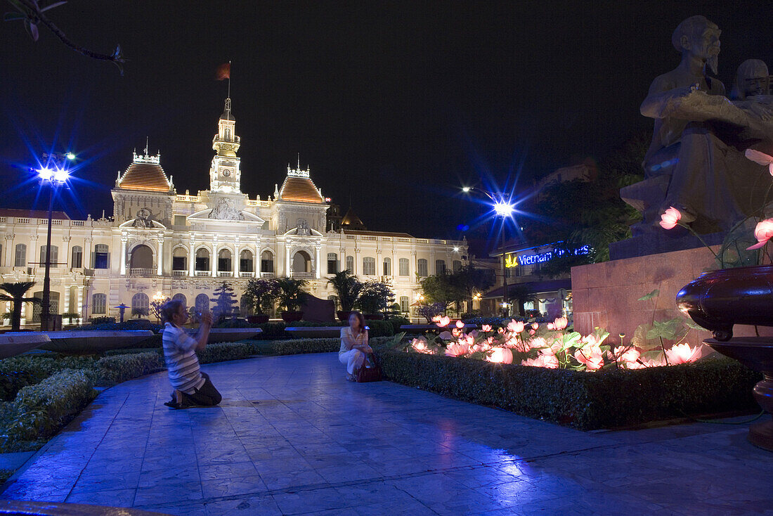 Town hall, people in front of the illuminated city hall downtown Saigon, Hoh Chi Minh City, Vietnam, Asia