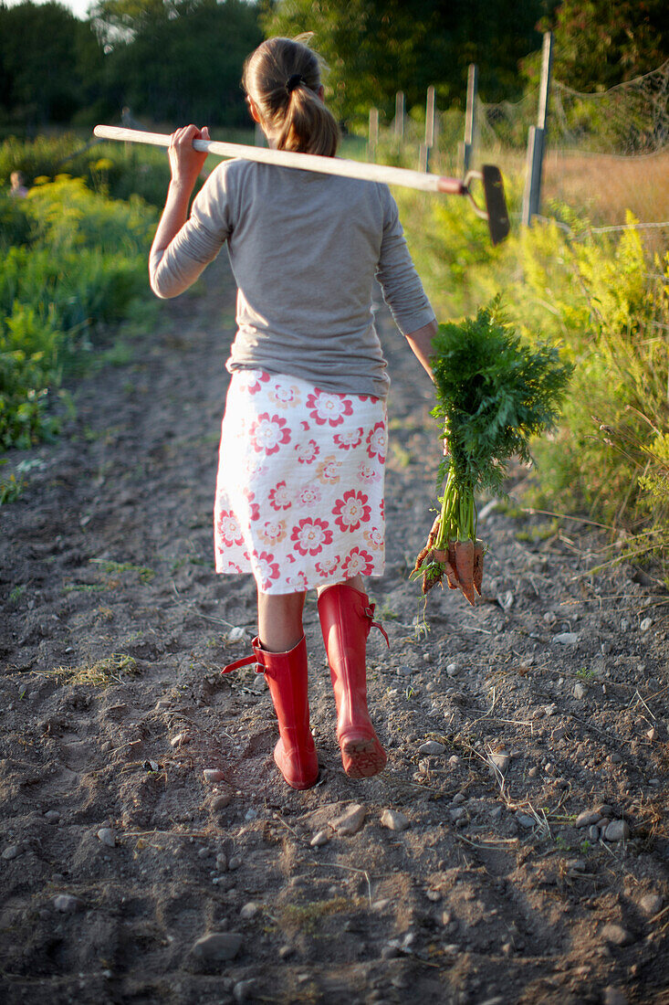 Mature woman in a vegetable garden, Lower Saxony, Germany