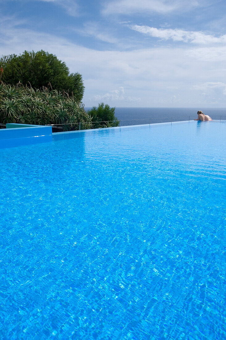 Couple in the outdoor pool at Estalagem da Ponta do Sol Design Hotel, Ponta do Sol, Madeira, Portugal