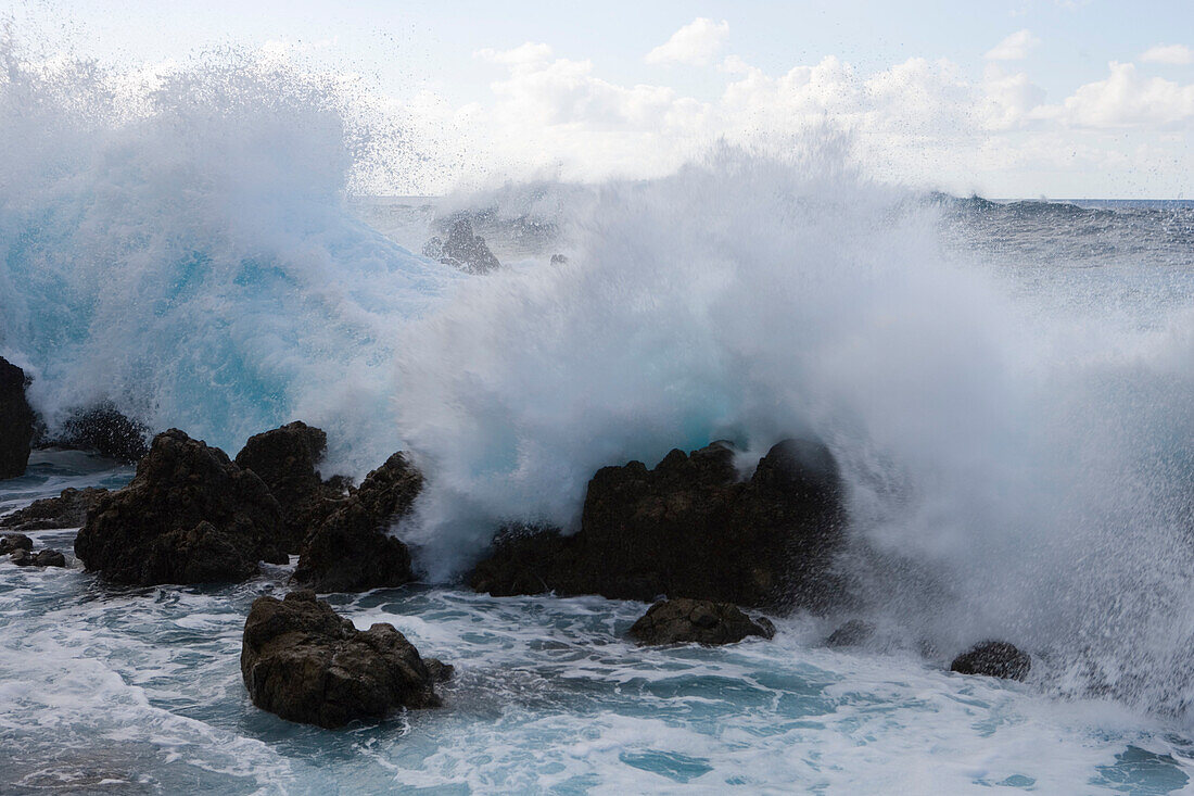 Wellen brechen an Felsen aus Lavastein, Porto Moniz, Madeira, Portugal