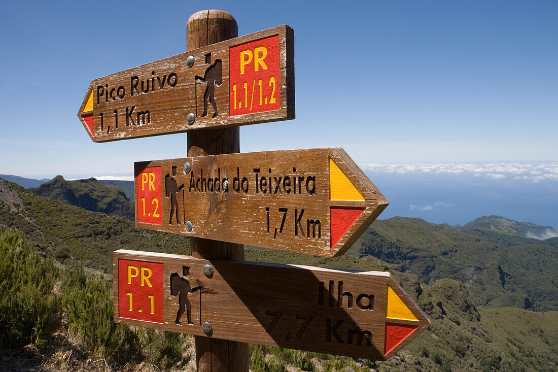 Trail signs pointing towards the summit of Pico Ruivo, Madeira, Portugal