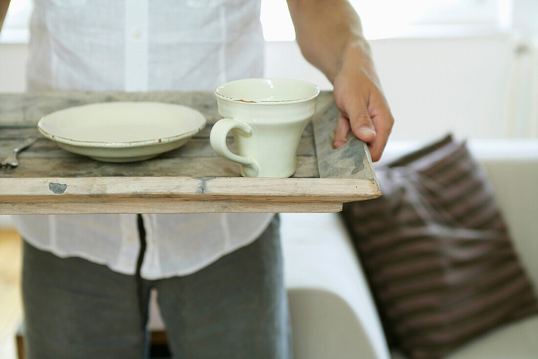 Man holding a tray with dishes, Styria, Austria