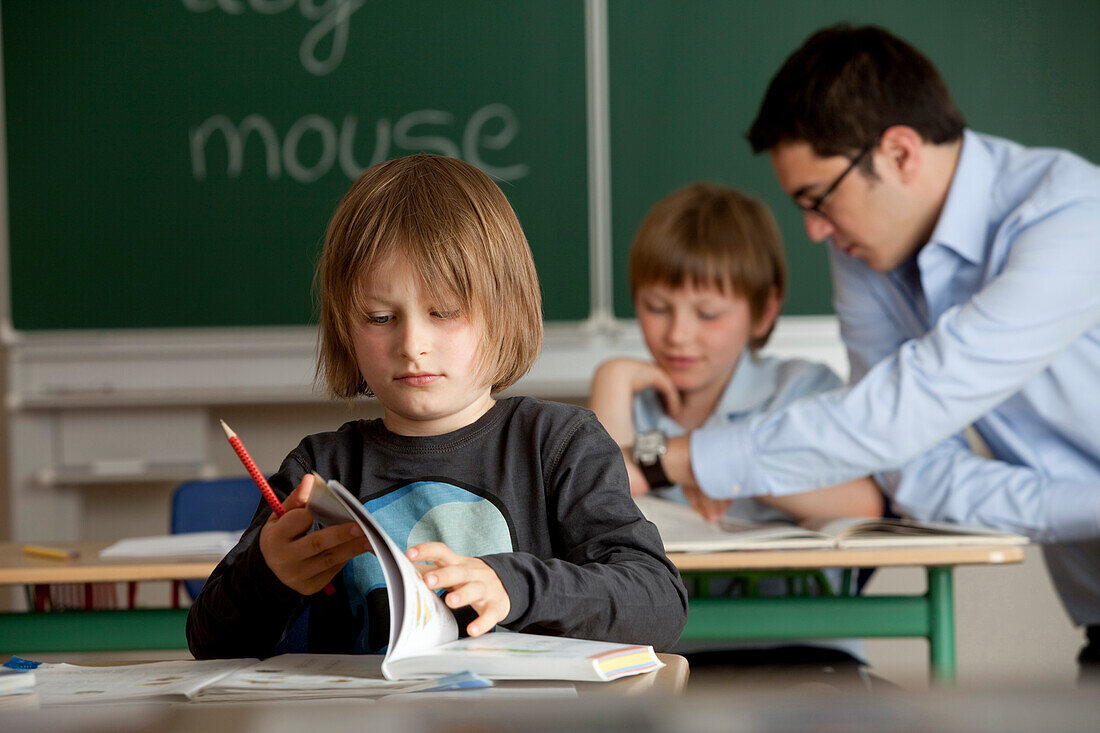 Schoolboys and male teacher in classroom, Hamburg, Germany