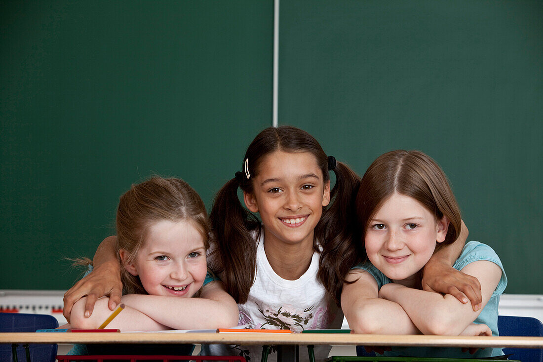 Three schoolgirls in classroom, Hamburg, Germany