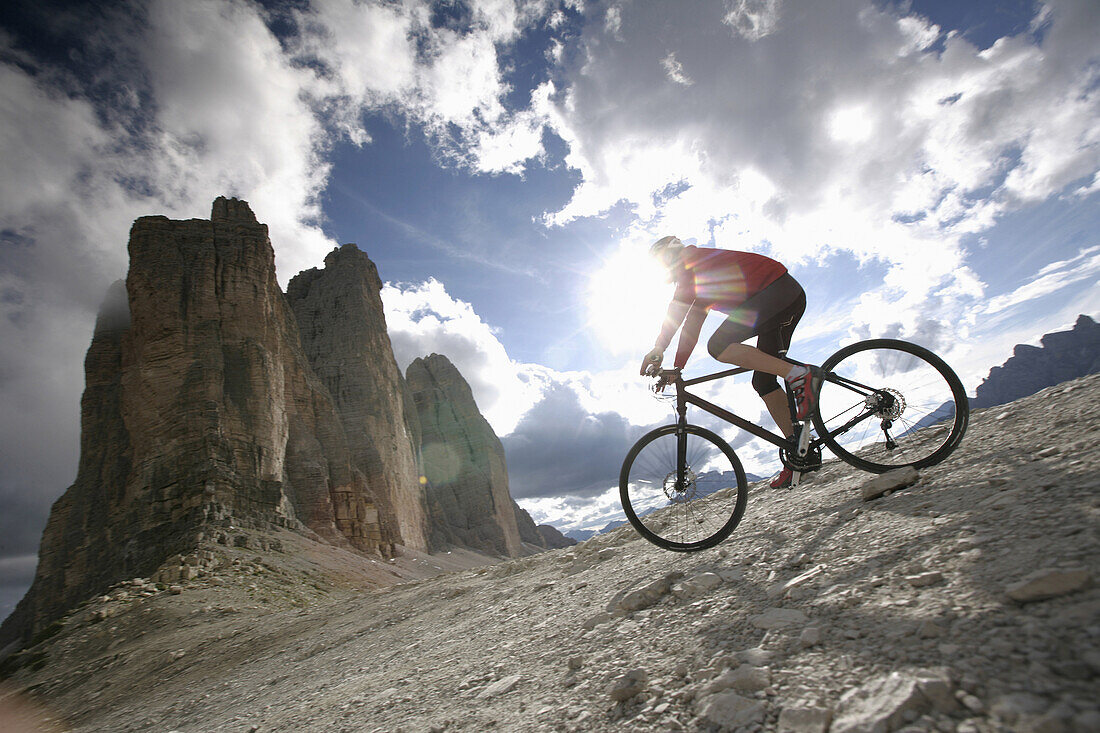 Person mountain biking near Tre Cime di Lavaredo, Veneto, Italy