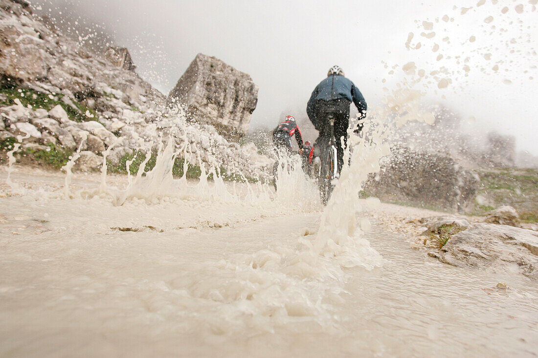 Persons mountain biking near Tre Cime di Lavaredo, Veneto, Italy