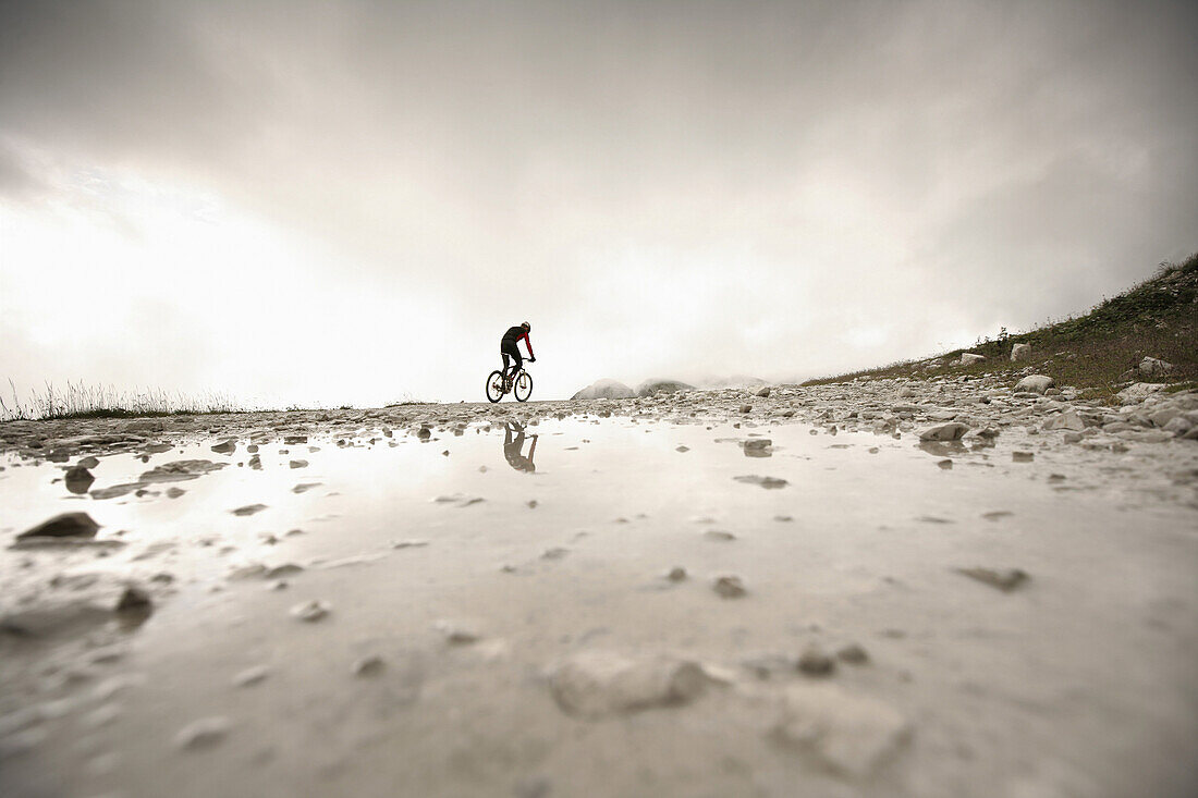 Person mountain biking near Tre Cime di Lavaredo, Veneto, Italy