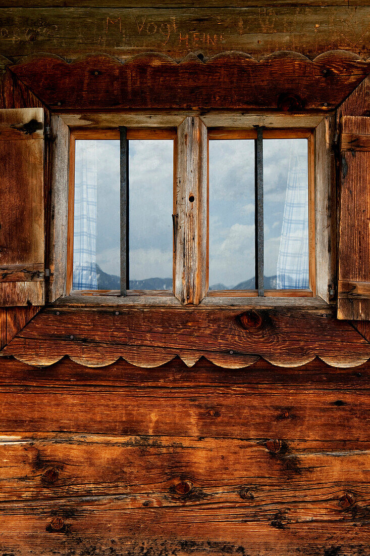 Window of an alpine hut on mountain Staffel, Jachenau, Alps, Bavaria, Germany