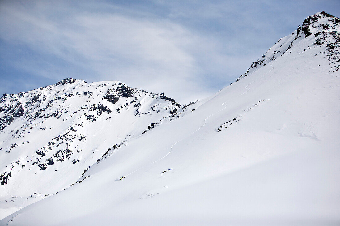 Snowboarder riding downhill in powder snow, Kappl, Tyrol, Austria