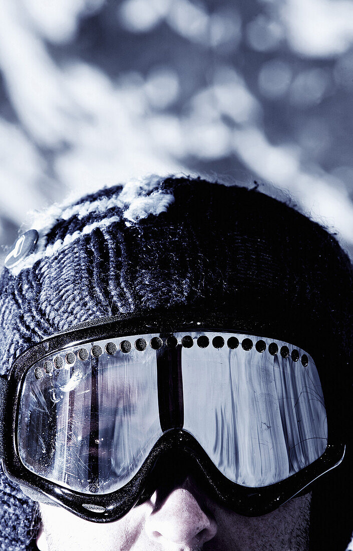 Snowboarder wearing ski goggles, Kappl, Tyrol, Austria