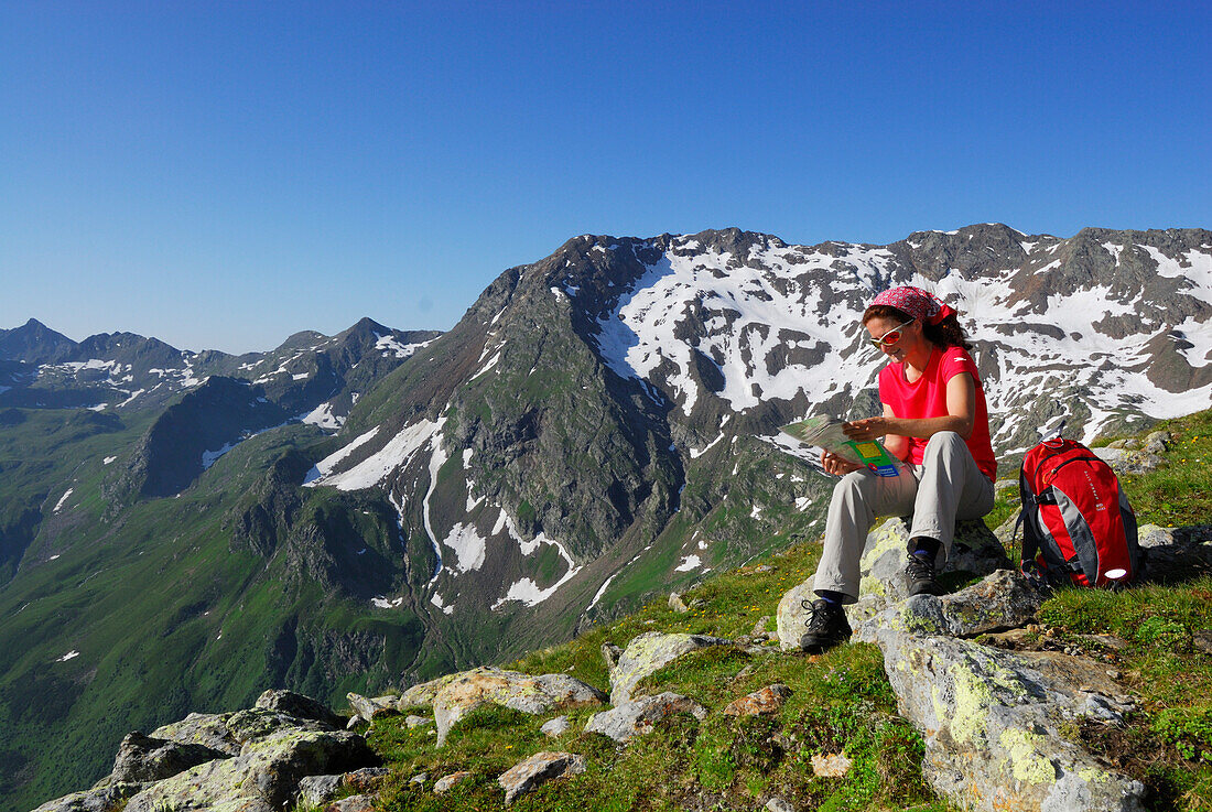 Female hiker reading map, Stubai Alps, Trentino-Alto Adige/South Tyrol, Italy