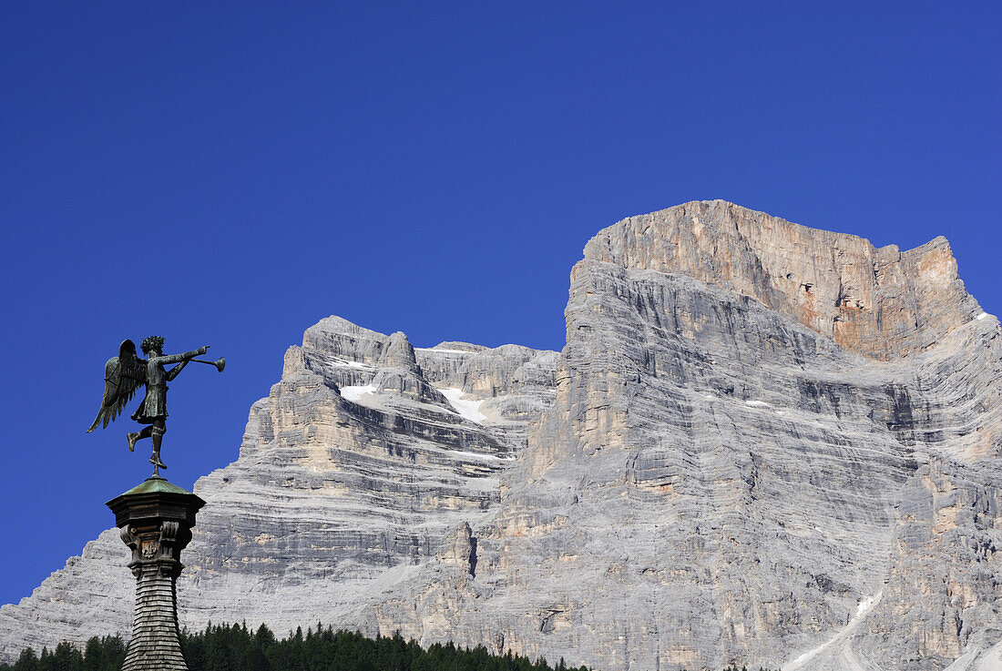 Statue of an angel on spire in front of Monte Pelmo, Dolomites, Veneto, Italy