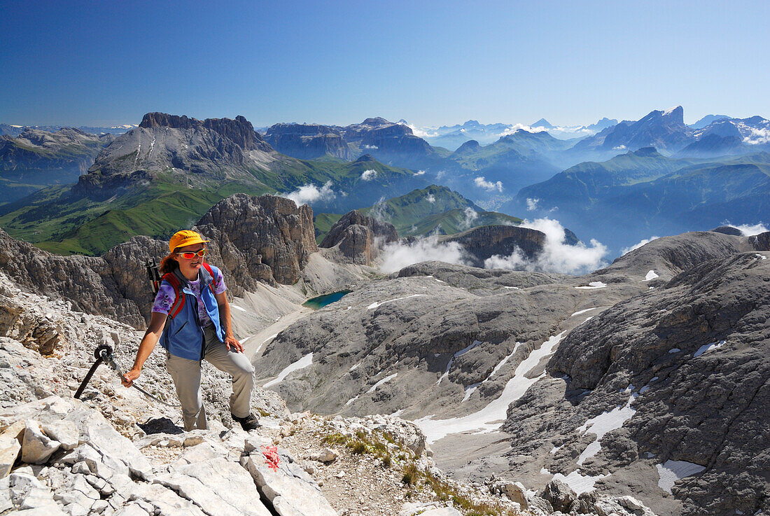 Woman ascending to mount Kesselkogel, Rosengarten group, Dolomites, Trentino-Alto Adige/South Tyrol, Italy