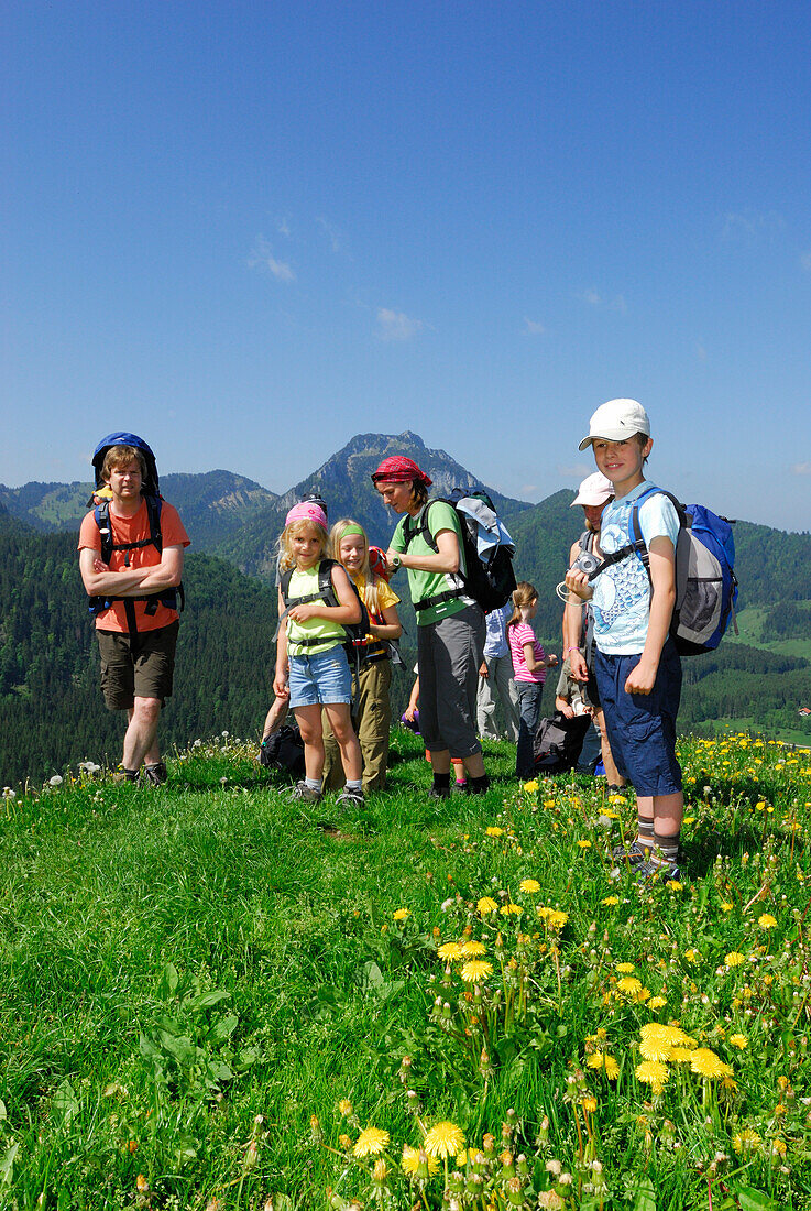 Group of hikers with children standing on meadow, Bavarian Alps, Upper Bavaria, Bavaria, Germany