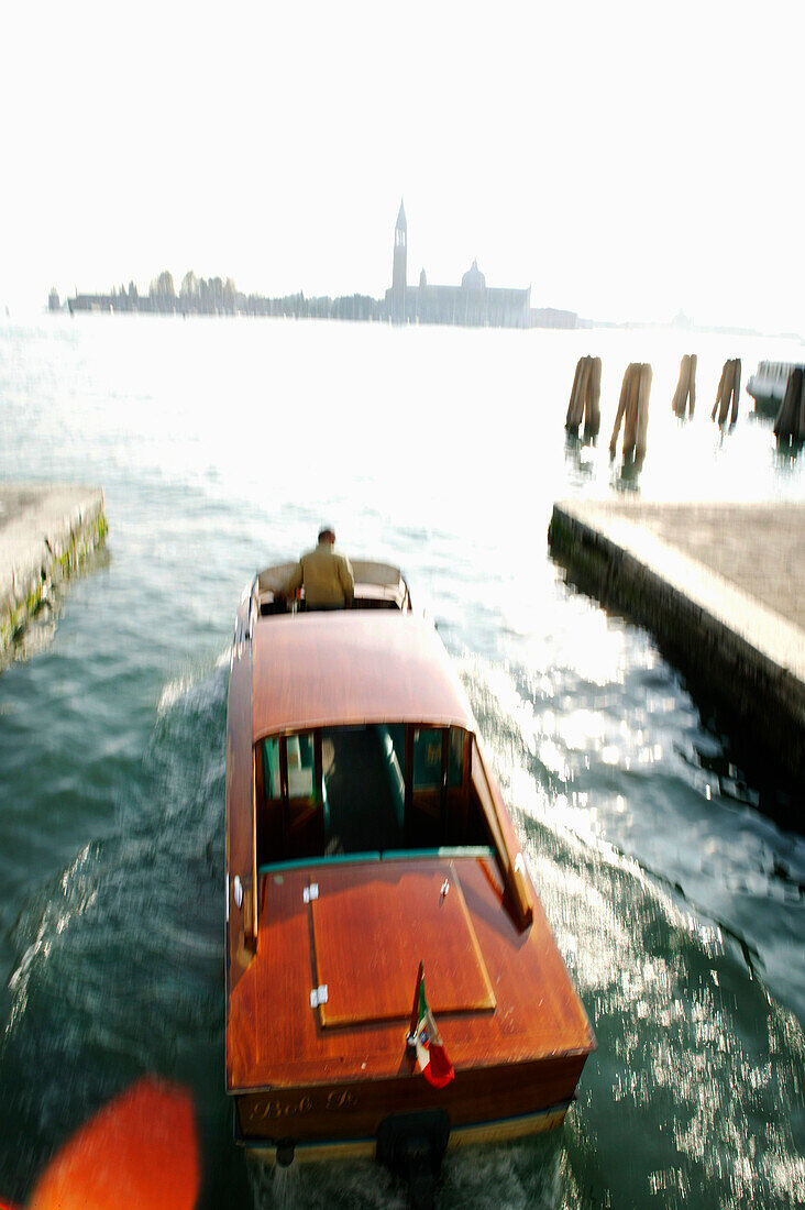 Water taxi with Campanile Tower and Basilica San Marco in backround, Venice, Italy