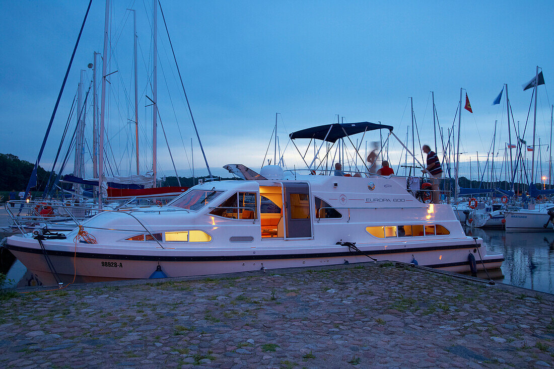 Evening at Stynort (Steinort) Marina, Houseboat and sailing boats on Lake Dargin (Jezioro Dargin), Mazurskie Pojezierze, East Prussia, Poland, Europe
