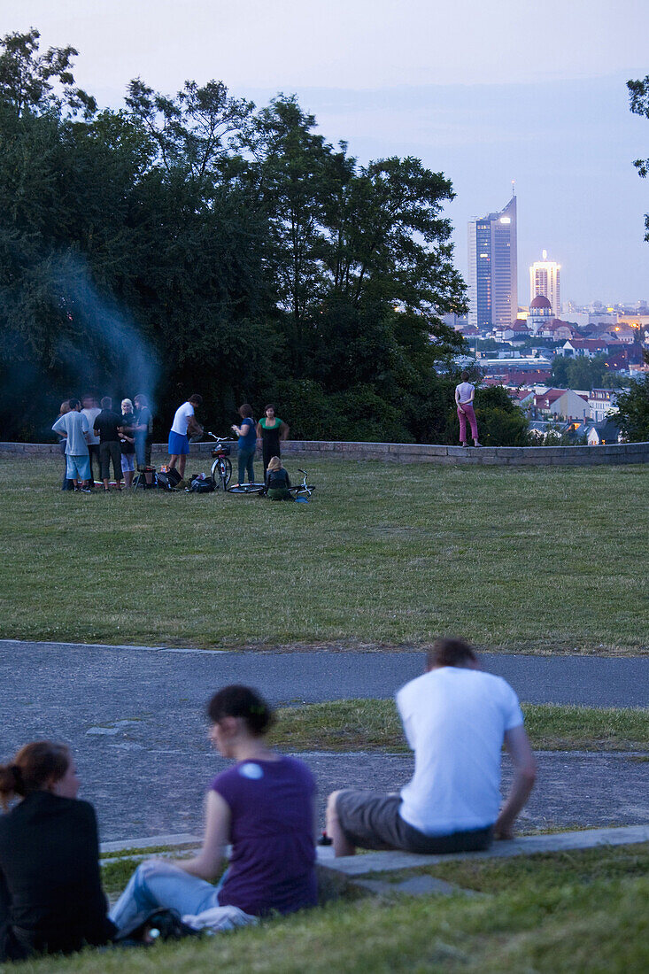 Young people on hill Fockeberg in the evening, Leipzig, Saxony, Germany