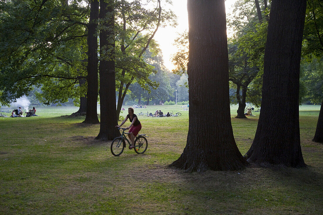 Woman bicycling in Clara Zetkin Park, Leipzig, Saxony, Germany