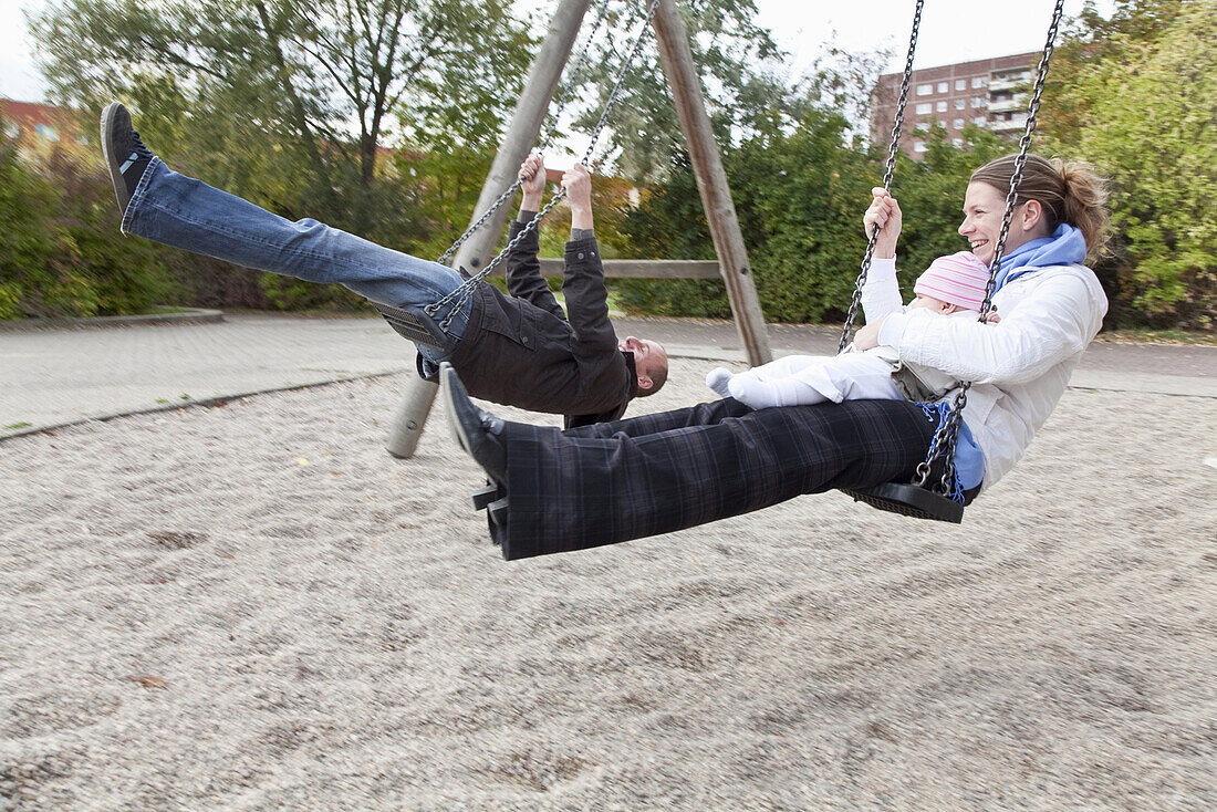 Family swinging, Leipzig, Saxony, Germany