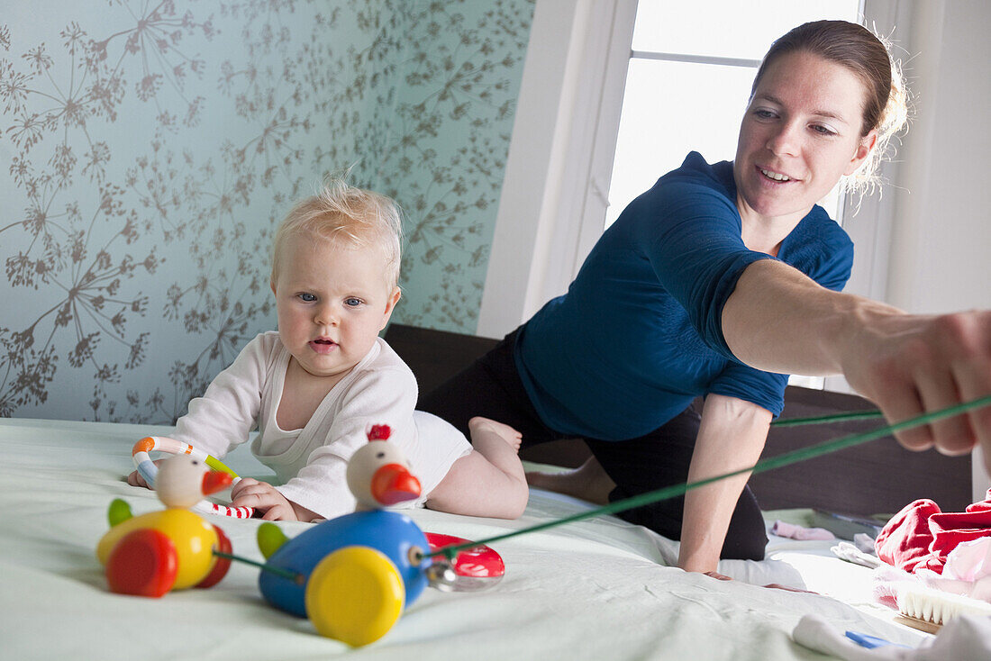 Mother and daughter (7 months) playing, Leipzig, Saxony, Germany