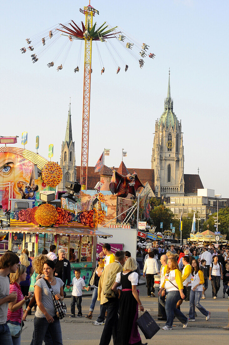 People at the Oktoberfest and St. Paul's church, Munich, Bavaria, Germany, Europe