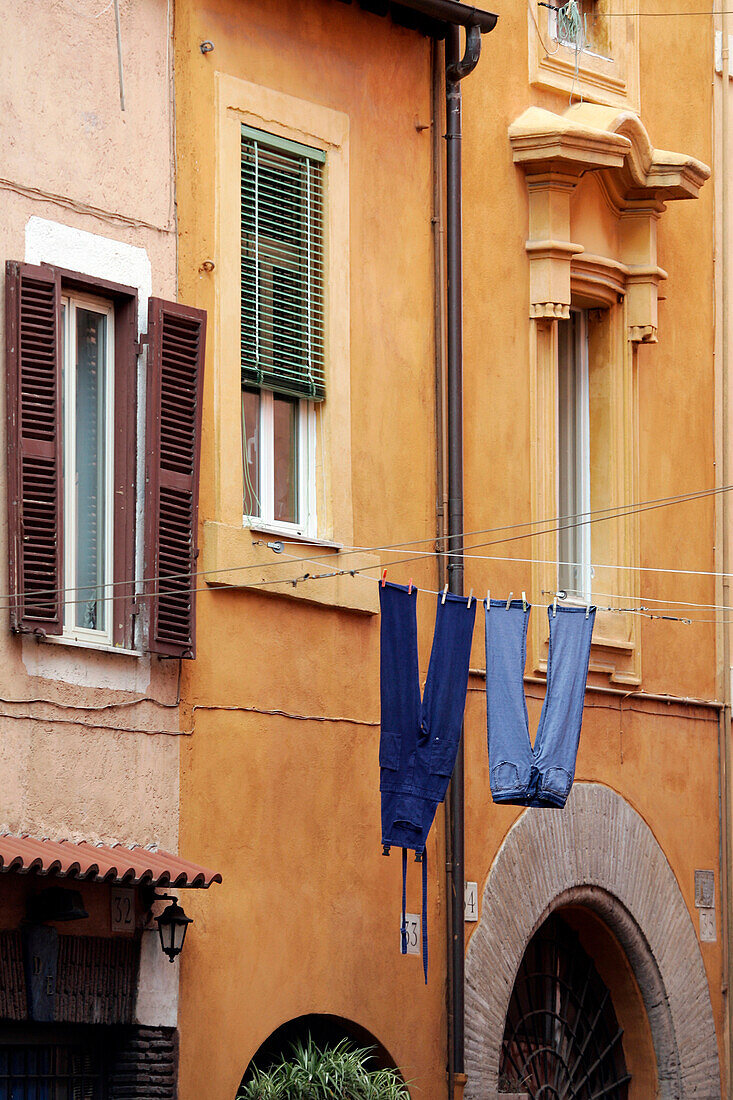 Laundry Hung Out To Dry Between Two Windows Over A Street, Trastevere Neighborhood, Rome, Italy