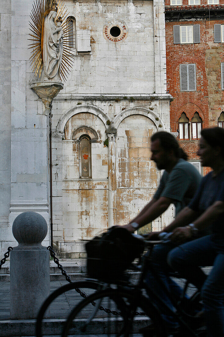Bike Ride In The Town, Virgin With Child, Facade Of The San Michele In Foro Church, Lucca, Tuscany, Italy