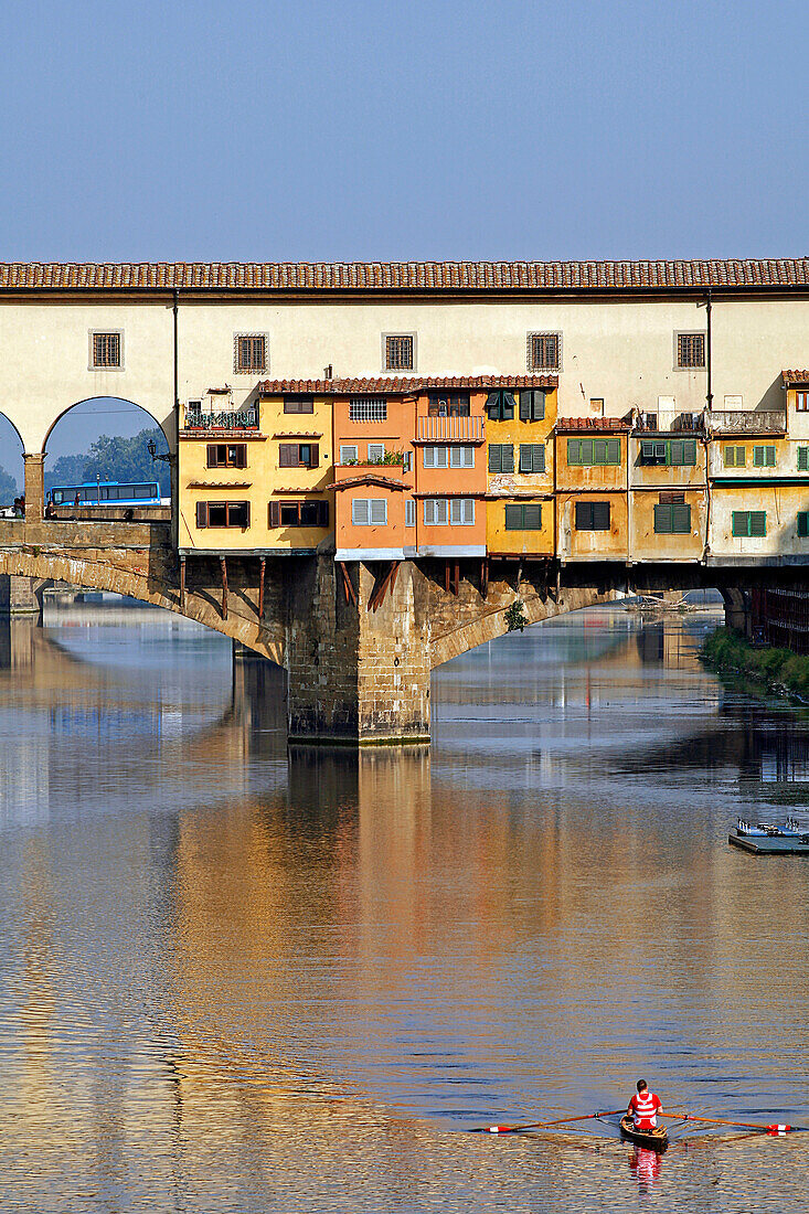 Rower On The River Arno In Front Of The Ponte Vecchio, Oldest Bridge In Florence, Tuscany, Italy