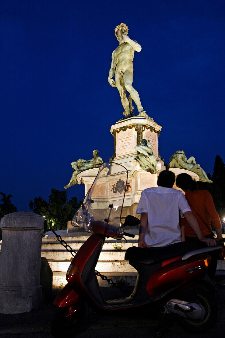 Lovers On A Scooter In Front Of The Statue Of David By Michelangelo, Piazzale Michelangelo, Florence, Tuscany, Italy