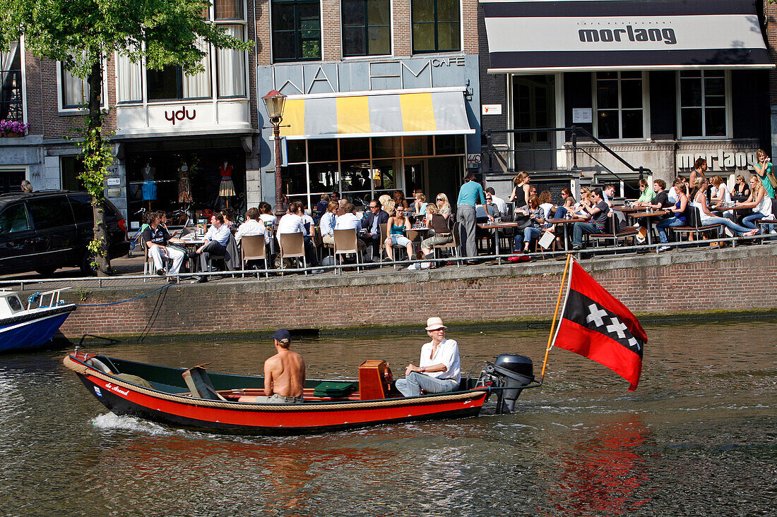 Boat With The Flag With Three Crosses, Emblem Of The City Of Amsterdam, And Cafe Walem Keizersgracht, Netherlands, Holland