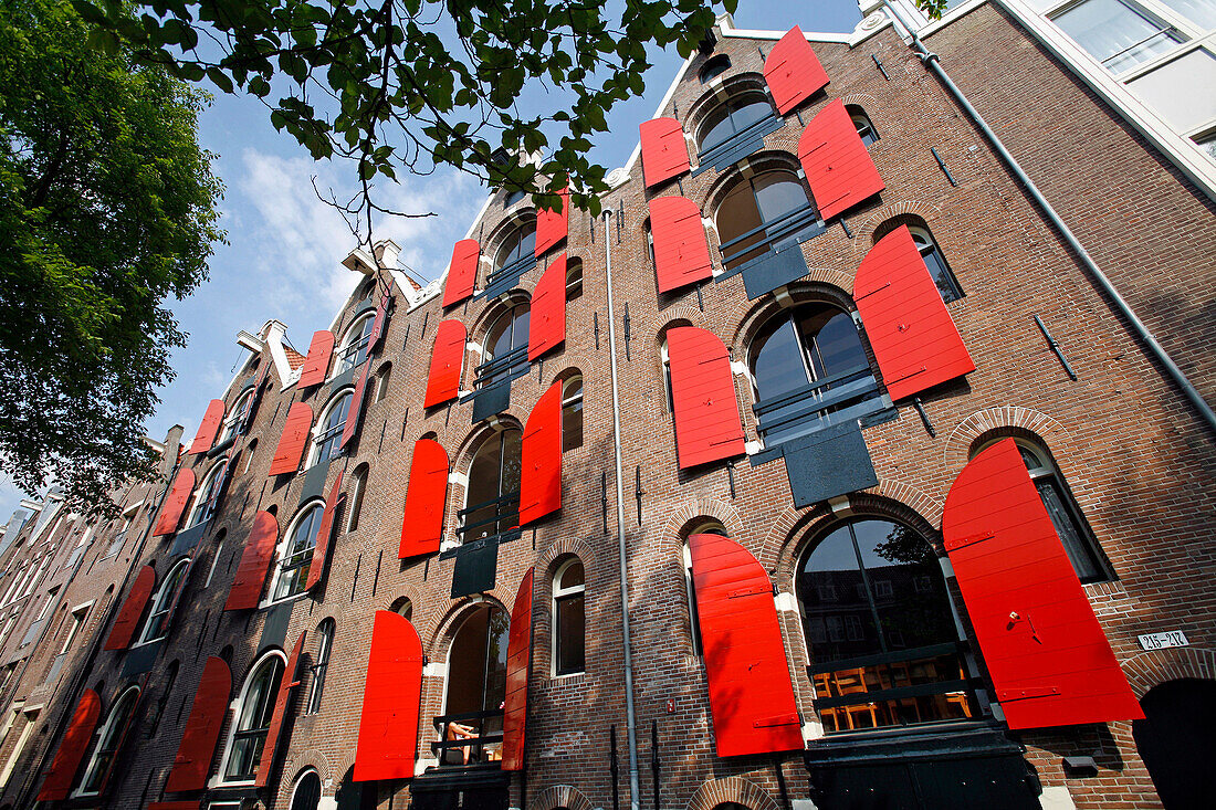 Facade Of A Traditional House With Orange Shutters