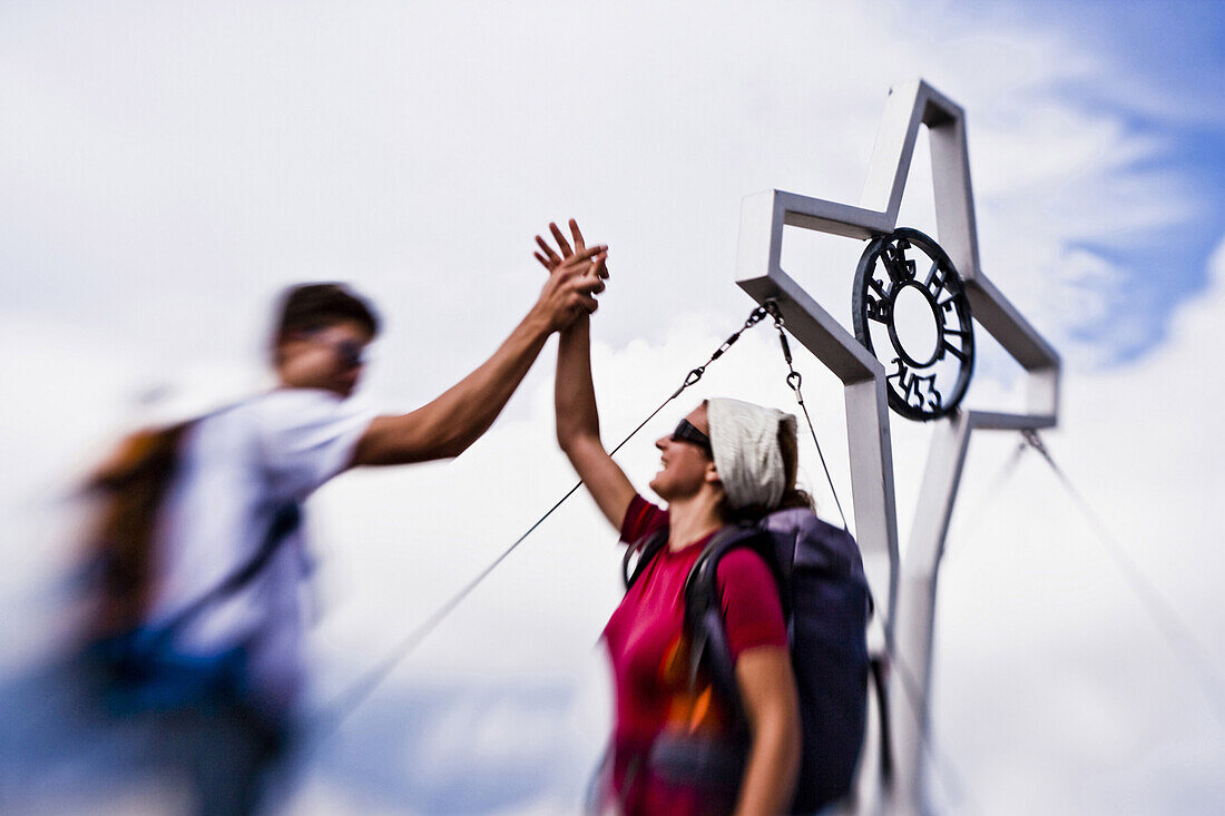 Woman and man on summit of Rumer Spitze, Innsbruck, Karwendel range, Tyrol, Austria