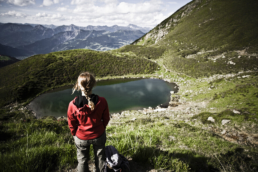 Woman looking over lake Tobelsee, Tschagguns, Montafon, Vorarlberg, Austria