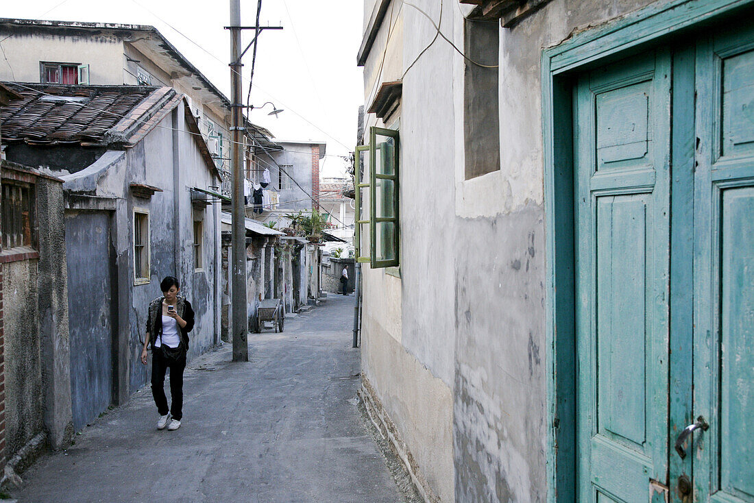 Woman at an alley, Gulangyu island, Xiamen, Fujian province, China, Asia