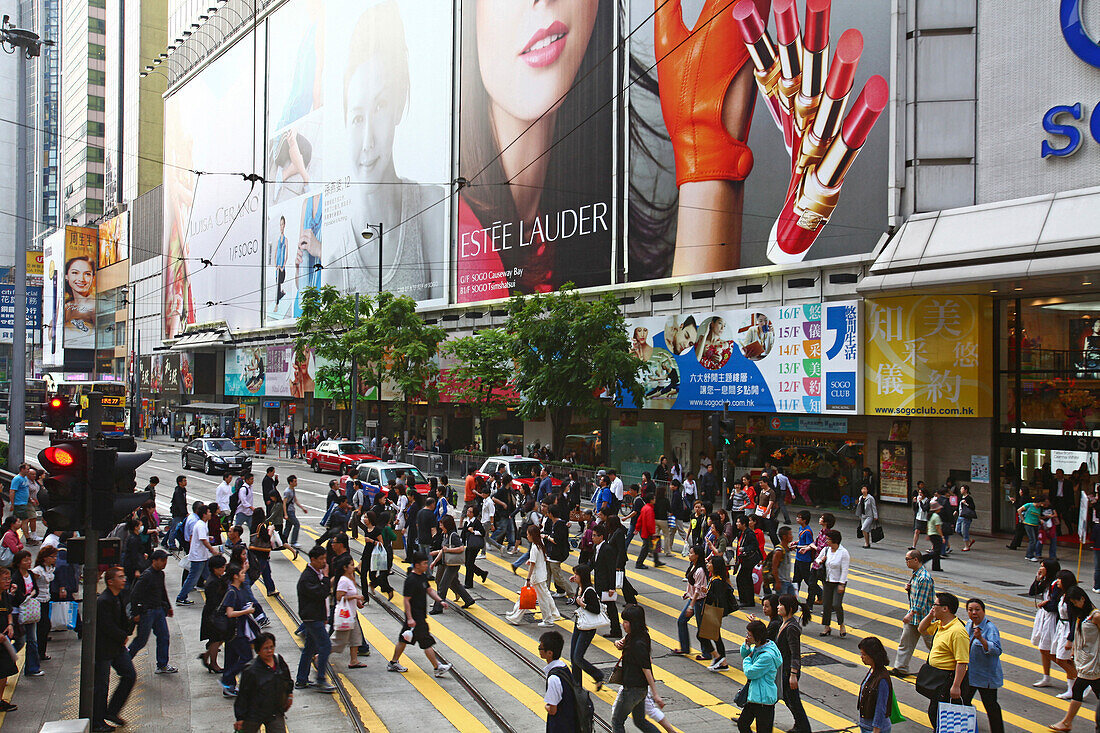 Pedestrians crossing the street in front of shopping center Central Plaza, Wanchai, Hong Kong, China, Asia
