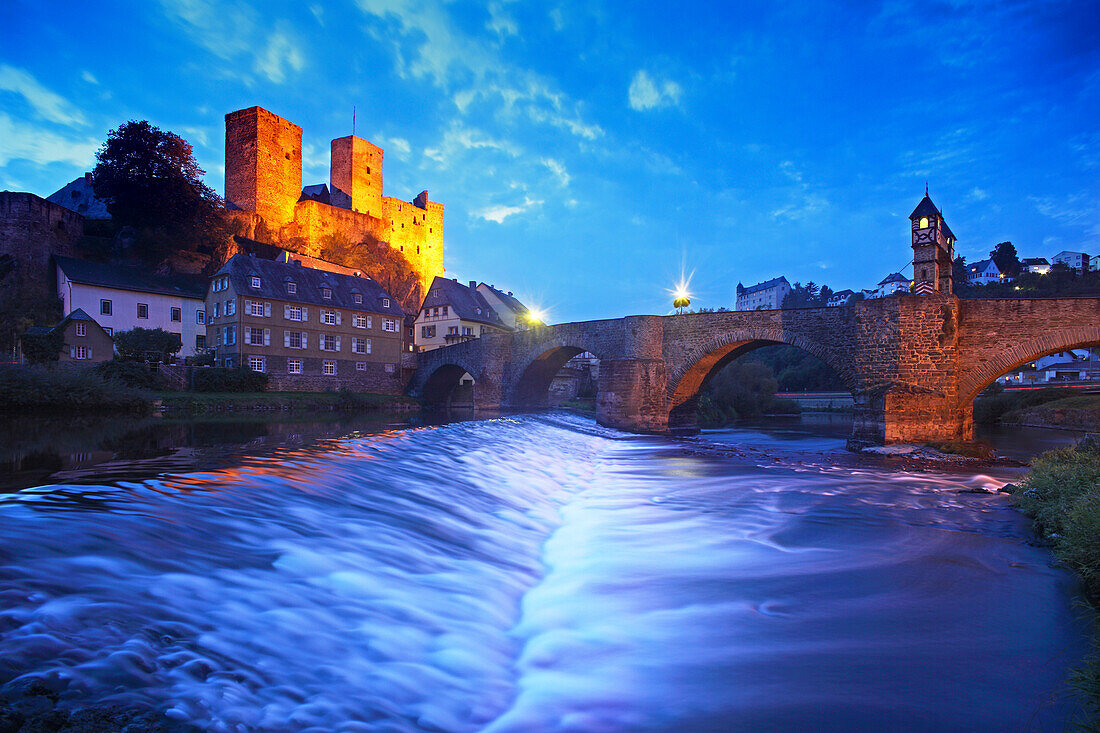 View over Lahn river with stone bridge to castle ruin, Runkel, Hesse, Germany