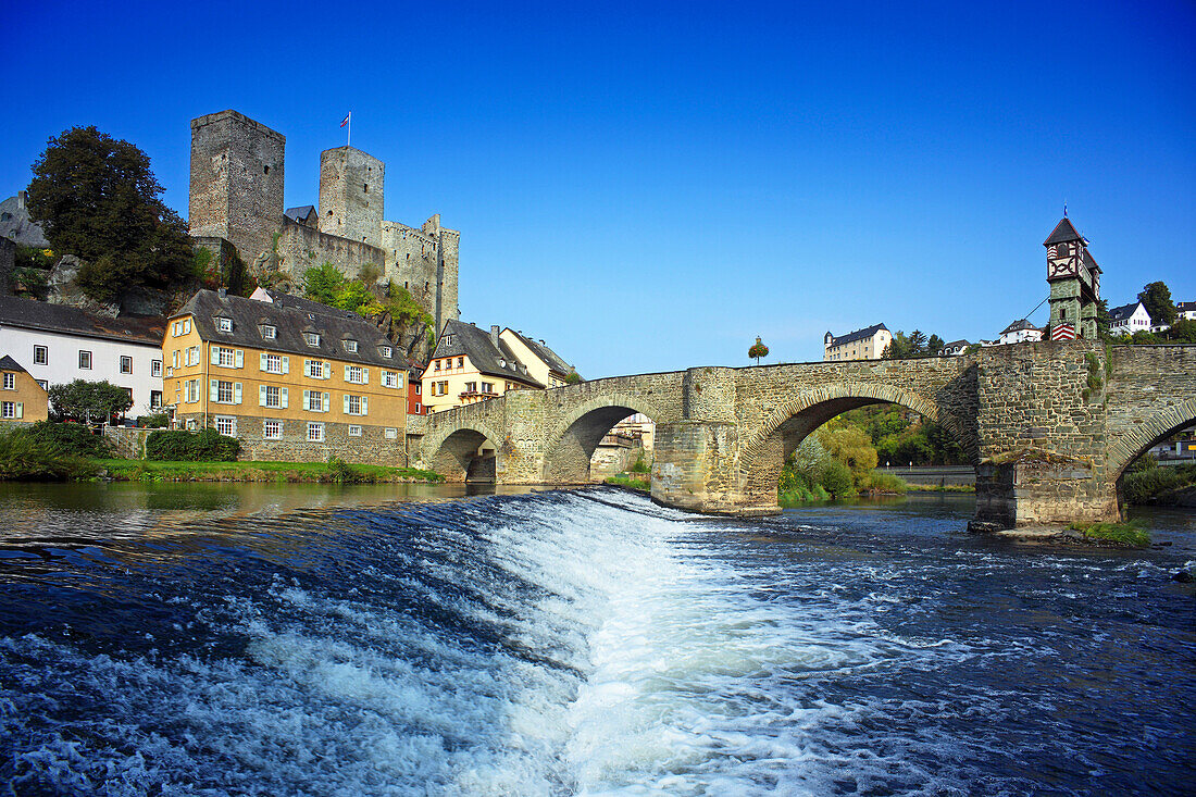 View over Lahn river with stone bridge to castle ruin, Runkel, Hesse, Germany