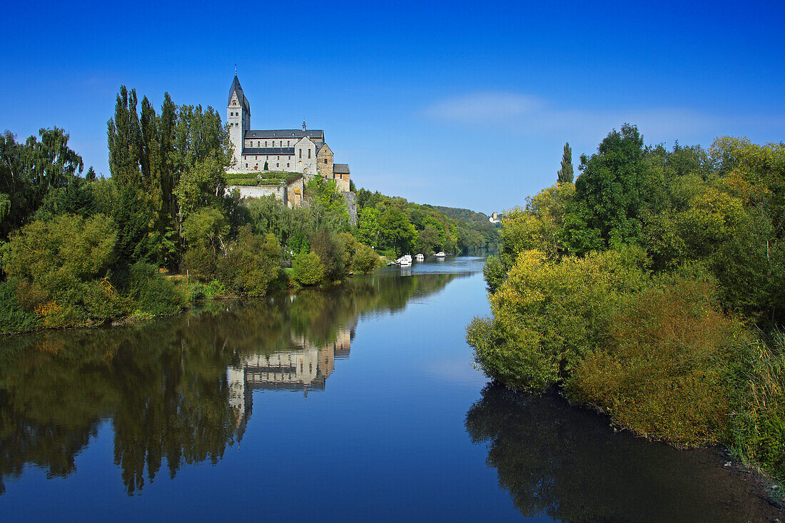 View over Lahn river to Lubentius Church, Dietkirchen, Hesse, Germany