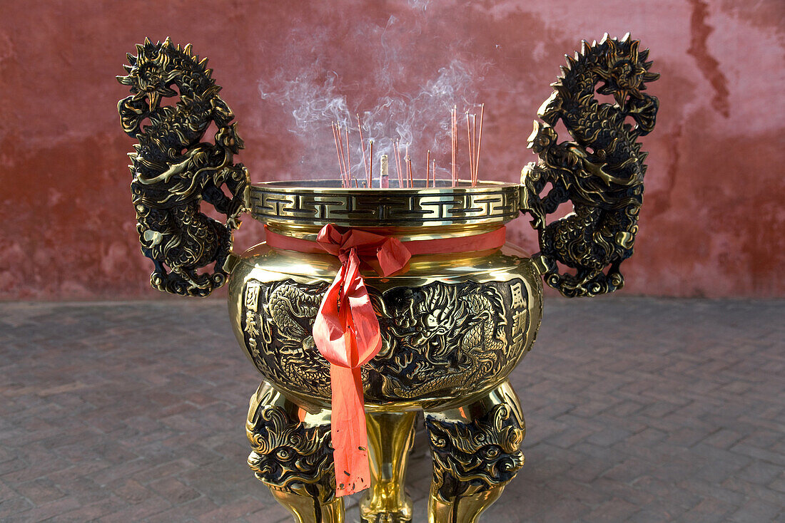 Vessel for incense sticks in front of red wall, Kuanti Temple, Tainan, Republic of China, Taiwan, Asia