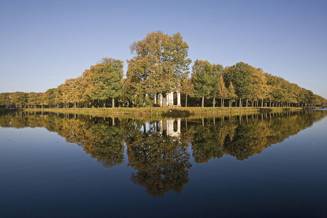 Reflection of trees in autumn on water ditch, Great Garden, Herrenhausen Gardens, Hanover, Lower Saxony, Germany