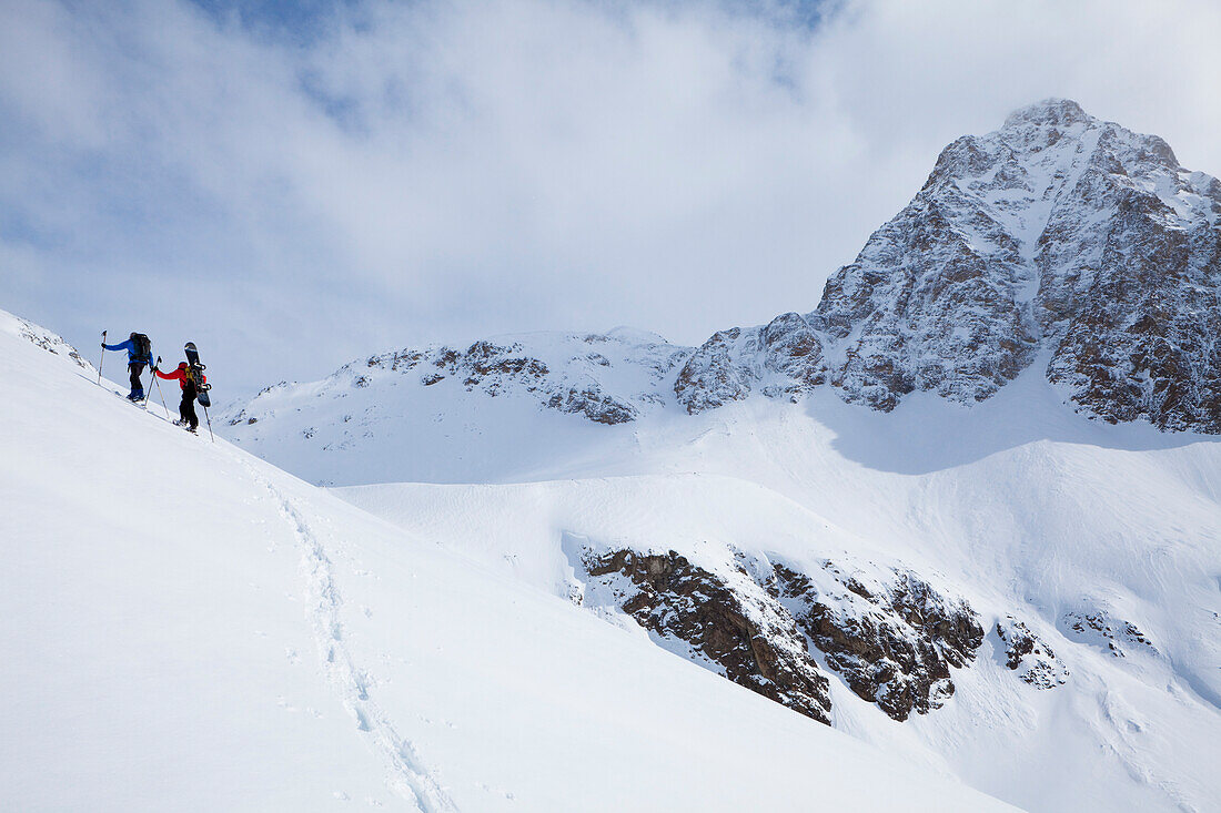 Skier and snowboarder ascending, Puschlav, Grisons, Switzerland