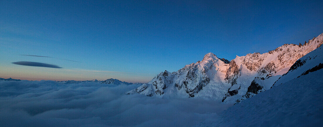 Mont Dolent with sea of fog in dawn, Val Ferret, Canton of Valais, Switzerland