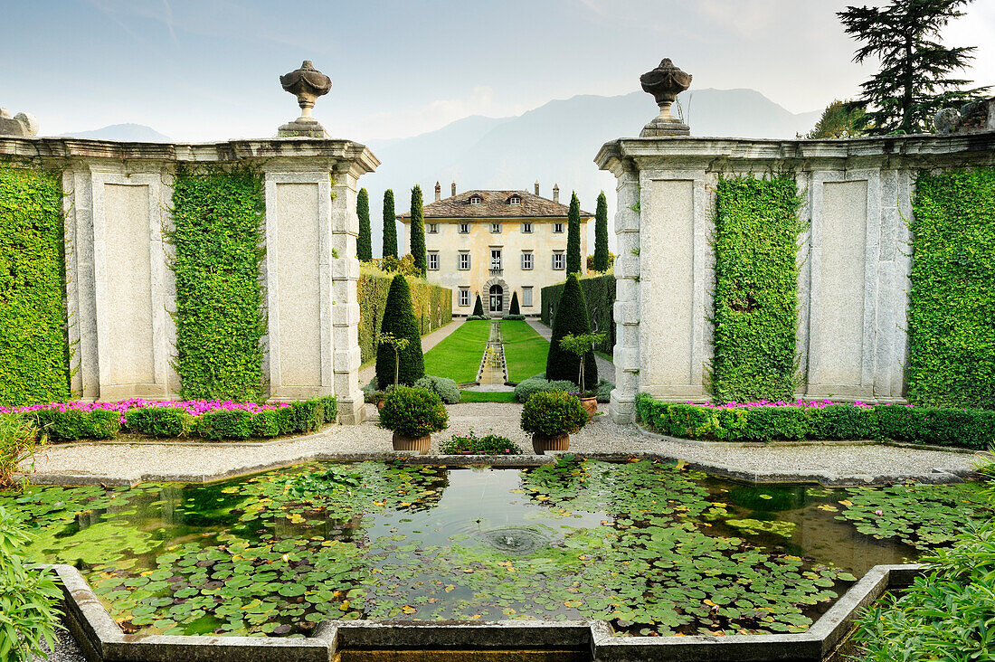 Fountain and garden with villa at Lake Como, Lombardy, Italy