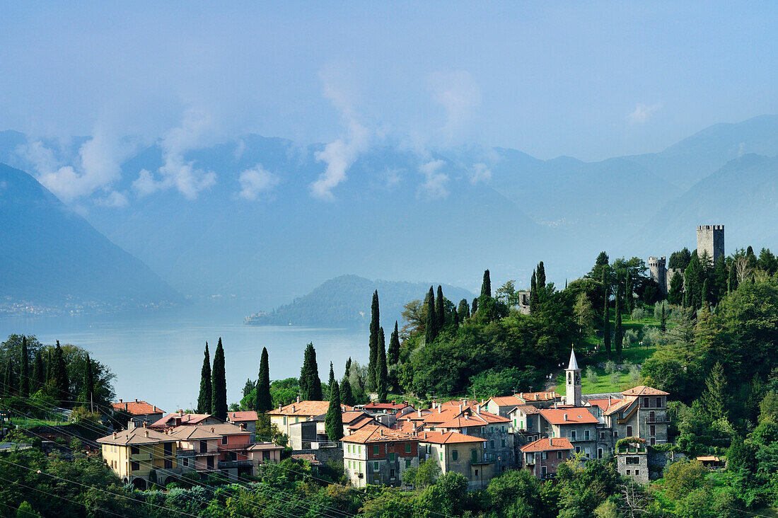 View to Vezio with cypresses and Castello di Vezio, Lake Como, Lombardy, Italy